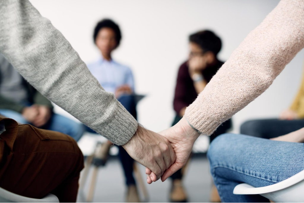 Two individuals holding hands, demonstrating encouragement and solidarity in outpatient rehab in Thousand Oaks, CA.