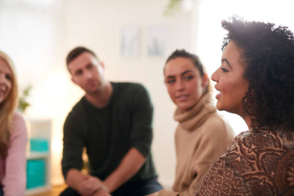 Group therapy session with individuals attentively listening and sharing, representing community support in outpatient rehab in Thousand Oaks, CA.