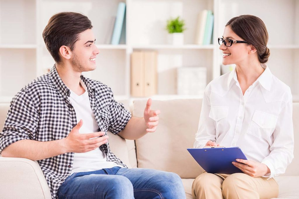 A therapist and patient engage in a friendly conversation during PTSD treatment in Thousand Oaks, CA.