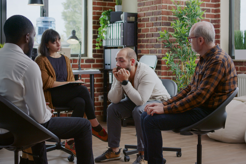 Group therapy session at a prescription drug rehab in Thousand Oaks, with participants discussing their recovery journeys and support strategies.