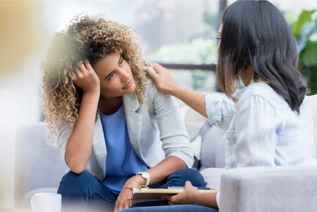 Caring counselor comforting a woman in distress, illustrating compassionate addiction treatment available in Thousand Oaks CA.