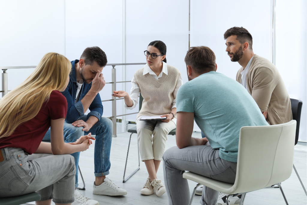 Group therapy session for addiction treatment in Thousand Oaks CA, with a supportive counselor guiding participants through their recovery journey