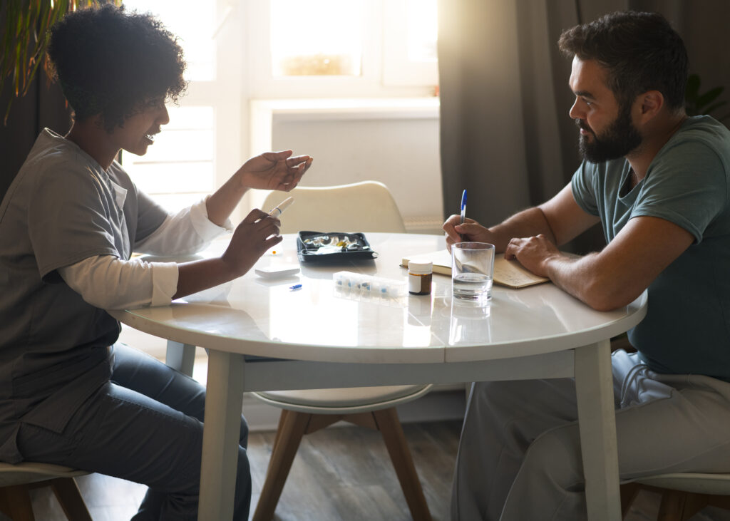 Patient and counselor discussing treatment options at a table, highlighting personalized addiction treatment services in Thousand Oaks CA.